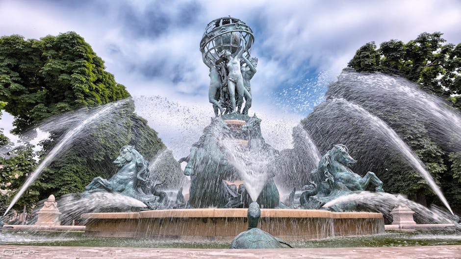 Stunning sculpture fountain with intricate water display at Jardin Marco Polo, Paris.