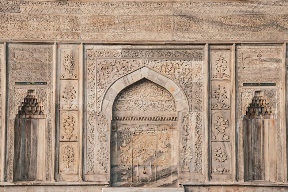 Beautifully carved stone facade featuring intricate Islamic patterns and ornate details.