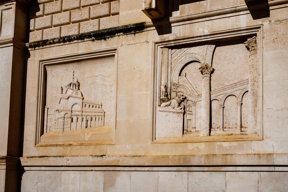 Close-up of intricate architectural relief on a Croatian building facade in sunlight.