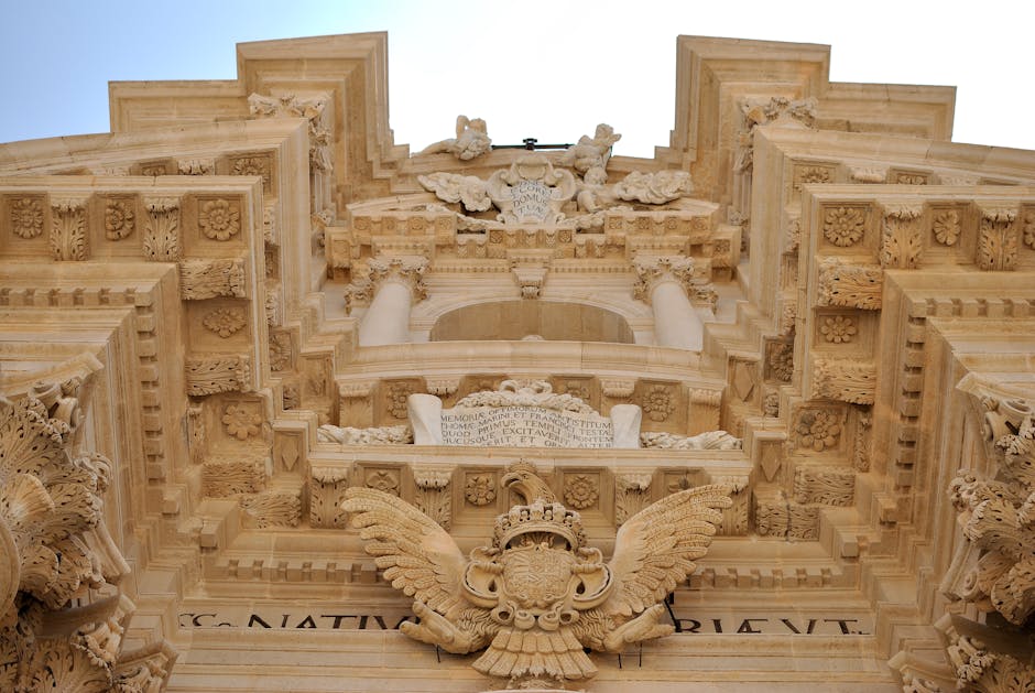 A breathtaking low-angle view of the ornate Baroque facade of Siracusa Cathedral in Sicily.