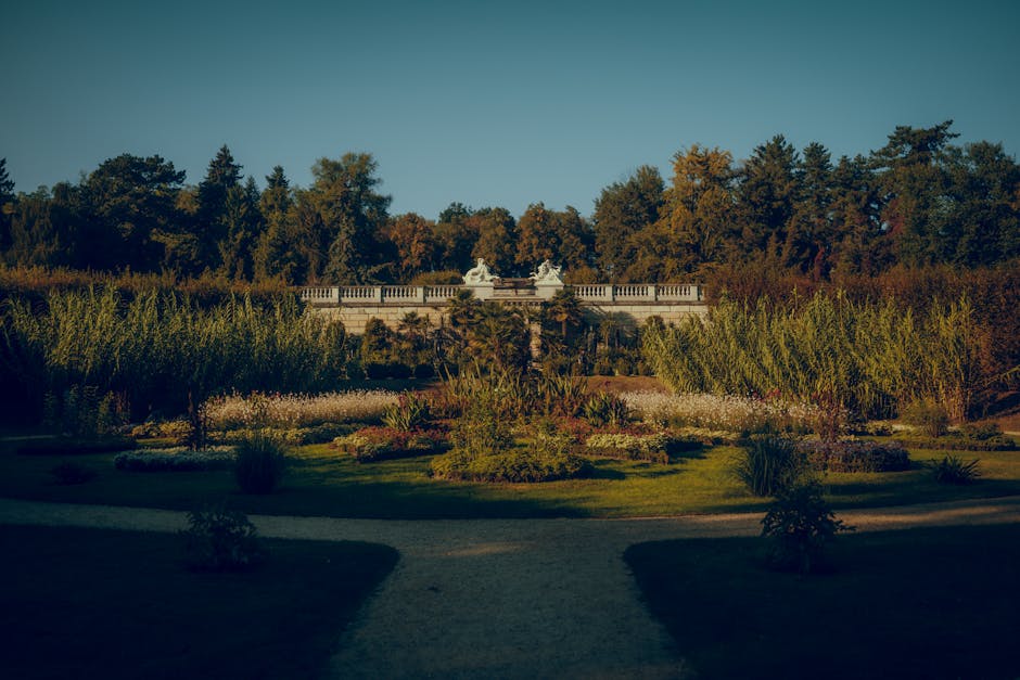 Tranquil view of Sanssouci Park's lush gardens and elegant architecture in Potsdam, Germany.